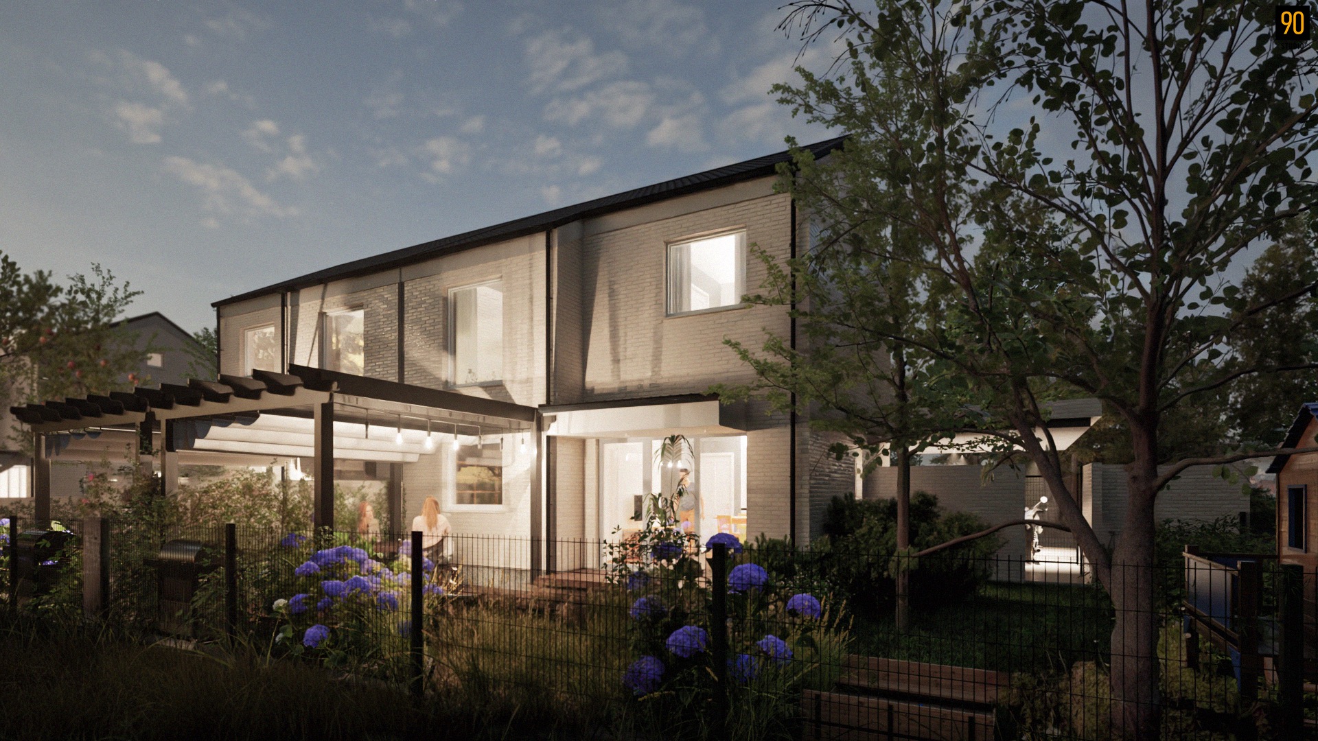 Nowoczesny dom z cegły z oświetlonym tarasem i pergolą, widok z ogrodu o zmierzchu. W tle błękitne hortensje i elementy architektury ogrodowej.