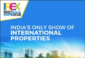Plakat reklamowy targów nieruchomości FEX Real Estate Expo 2018 z hasłem 'India's Only Show of International Properties' na tle błękitnego nieba i panoramy miasta.