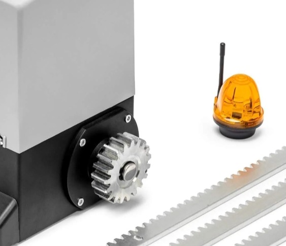 Napęd bramy przesuwnej z zębatką i lampą ostrzegawczą. Widok z bliska na mechanizm i akcesoria montażowe na białym tle.