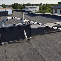 Montaż instalacji do klimatyzacji multisplit na dachu. Przewody miedziane do podłączenia na dachu do agregatu.