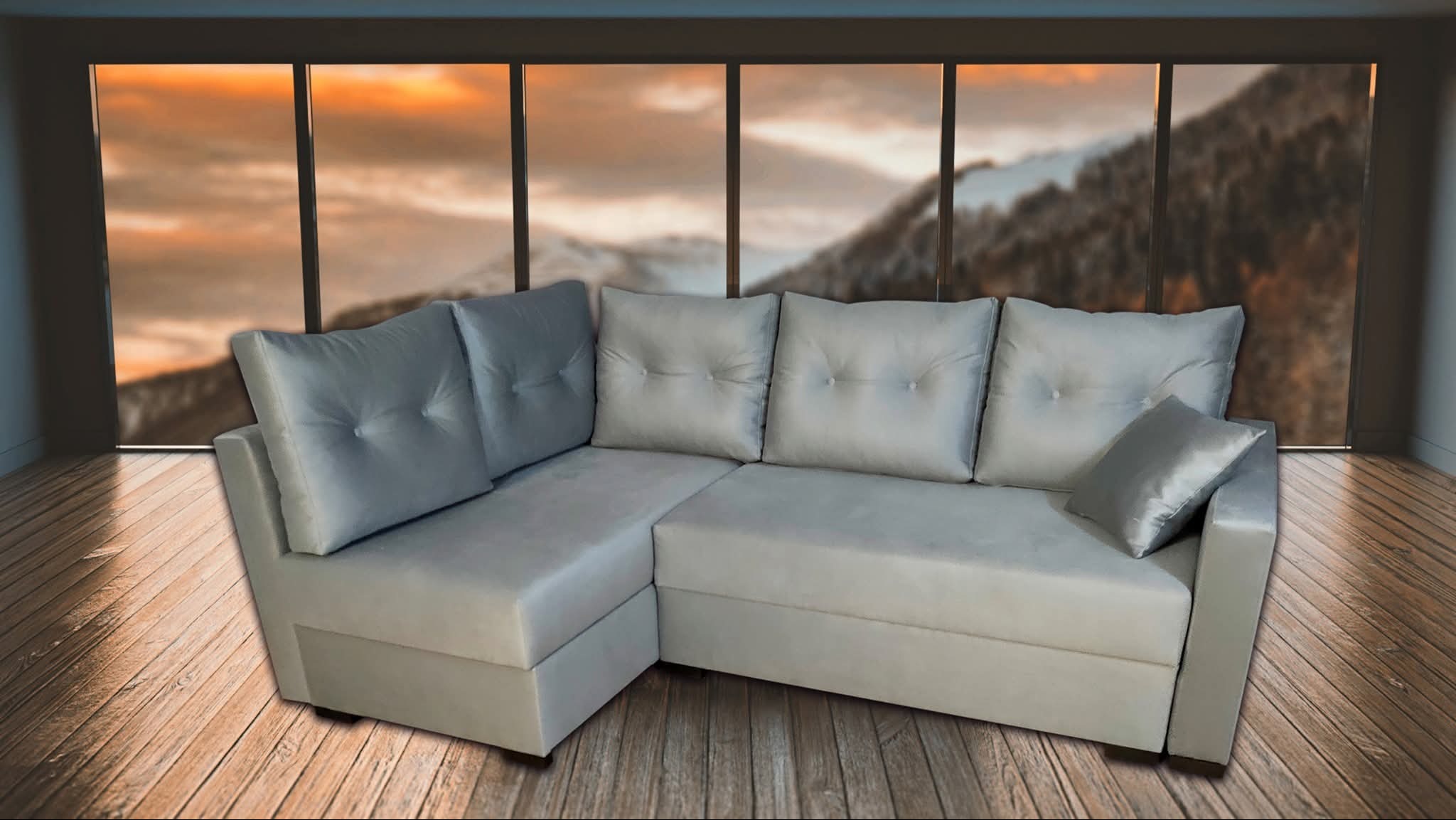 Szary narożnik z poduszkami na tle okna z widokiem na góry o zachodzie słońca, na drewnianej podłodze. Minimalistyczny design, miękkie linie.