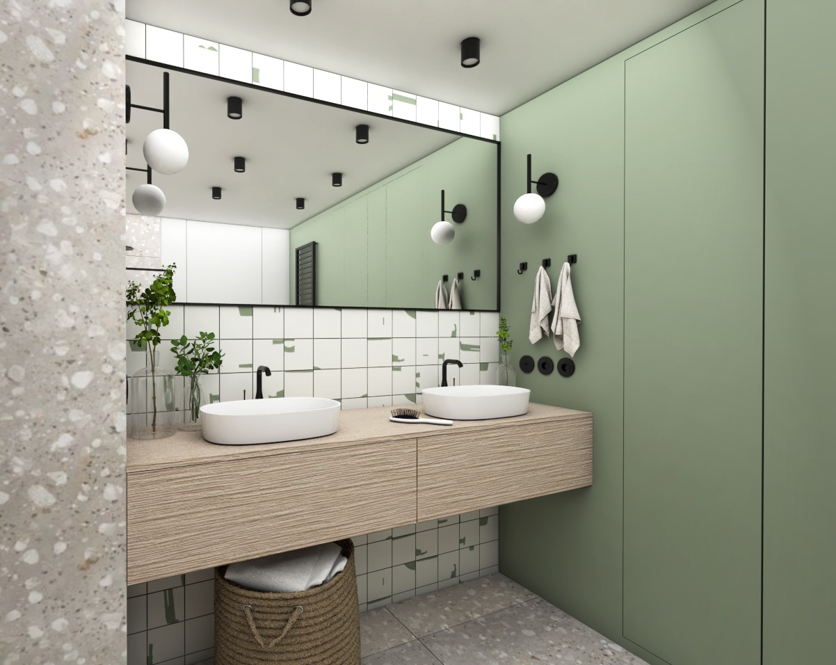 Nowoczesna łazienka z dwoma owalnymi umywalkami nablatowymi, drewnopodobna szafka pod umywalkami, zielona ściana i duża szafa w kolorze ściany, lustro z czarną ramą i okrągłymi lampami, kosz...