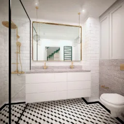 Nowoczesna łazienka z białymi płytkami metra, czarno-białą podłogą w geometryczny wzór, złotą armaturą i kabiną prysznicową typu walk-in.
