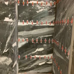 BestTiler - Układanie marmurowych płytek w kabinie prysznicowej z użyciem systemu poziomowania płytek z czerwonymi klipsami, widoczny odpływ liniowy.