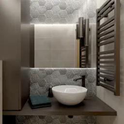 Nowoczesna łazienka z umywalką nablatową, heksagonalnymi płytkami, podświetlanym lustrem i grzejnikiem drabinkowym w odcieniach szarości i brązu.
