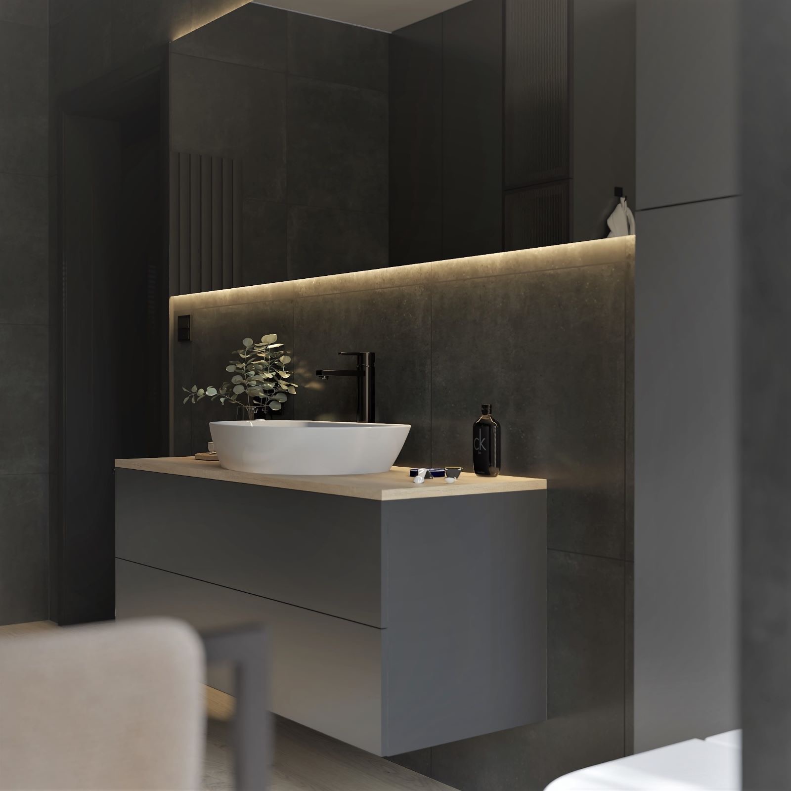 Nowoczesna łazienka w odcieniach szarości z podświetlanym lustrem, białą nablatową umywalką, czarną armaturą i minimalistycznym wystrojem.