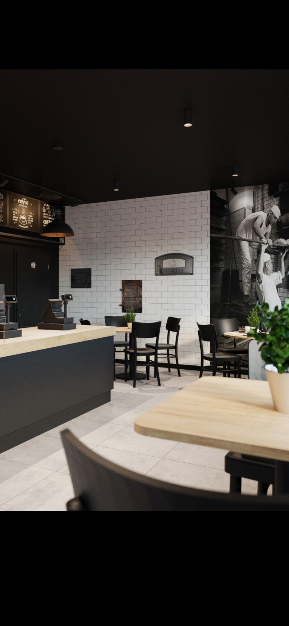 Wnętrze kawiarni z czarnymi krzesłami i drewnianymi stolikami, białe płytki na ścianach i dekoracyjna grafika. Nowoczesny design z elementami retro.