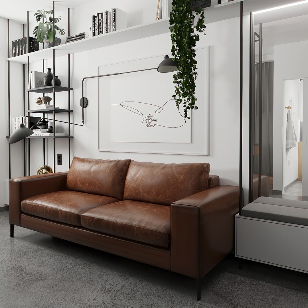 Nowoczesny salon z brązową skórzaną sofą, minimalistycznym regałem i abstrakcyjnym obrazem na ścianie, uzupełniony zwisającą rośliną i szarą pufą.