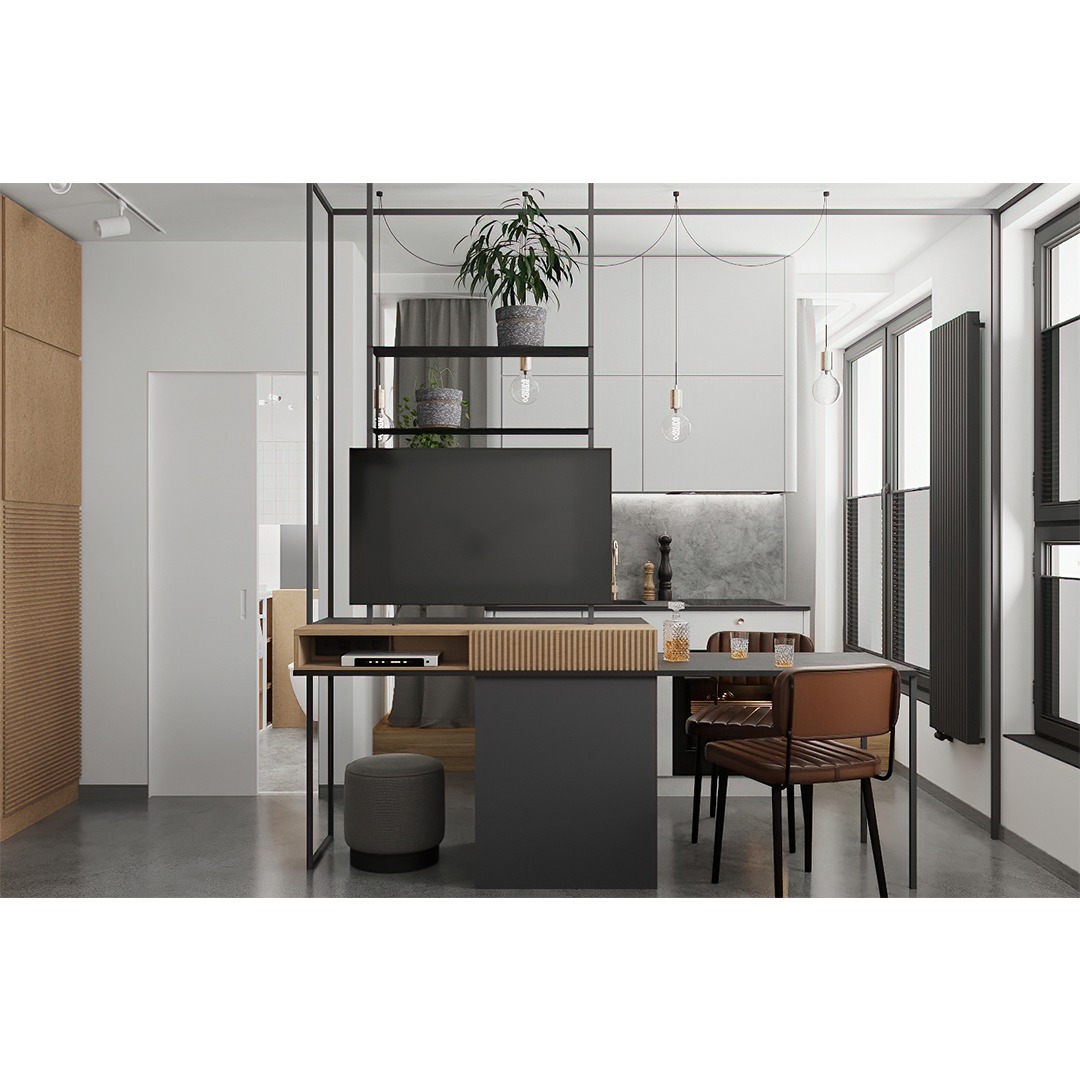 Nowoczesne wnętrze: salon z aneksem kuchennym oddzielone metalową konstrukcją z półkami, telewizorem i blatem stołu. Widoczne krzesła, dekoracje, oświetlenie i elementy wyposażenia.