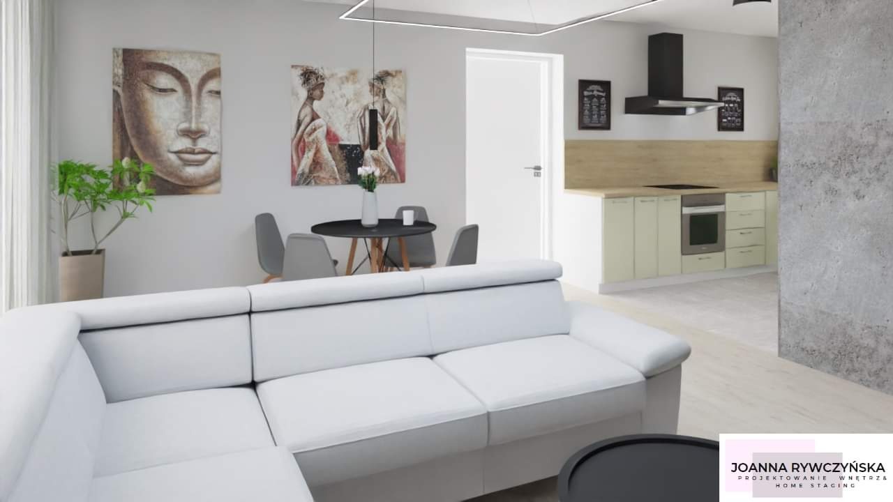 Nowoczesne wnętrze z białym narożnikiem, okrągłym stołem z szarymi krzesłami, kuchnią w tle i dekoracyjnymi obrazami na ścianie.