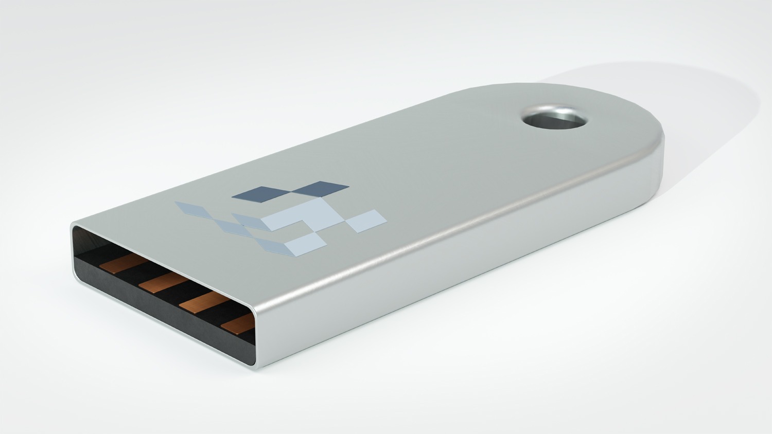 Srebrny pendrive z nadrukowanym geometrycznym wzorem w odcieniach szarości, leżący na białym tle.