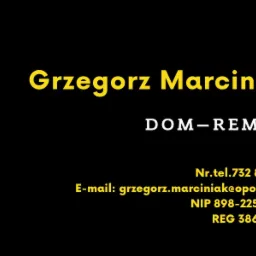 Wizytówka firmy budowlanej DOM-REMBID z imieniem i nazwiskiem Grzegorz Marciniak, numerem telefonu, adresem e-mail, NIP i REGON na czarnym tle.