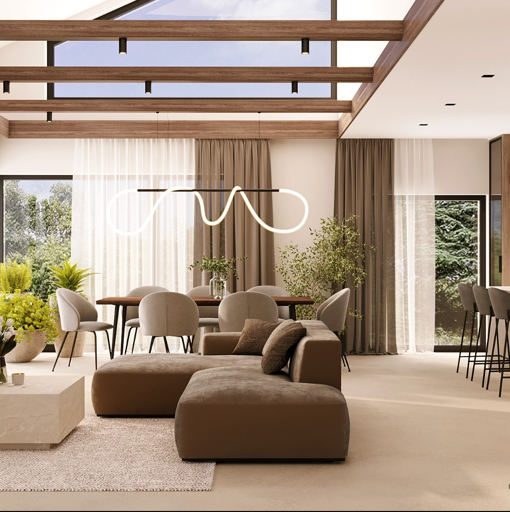 Jasne, przestronne wnętrze salonu z jadalnią, z brązową sofą modułową, drewnianym stołem jadalnym i nowoczesną lampą LED, doświetlone przez duże okna i świetlik w suficie.