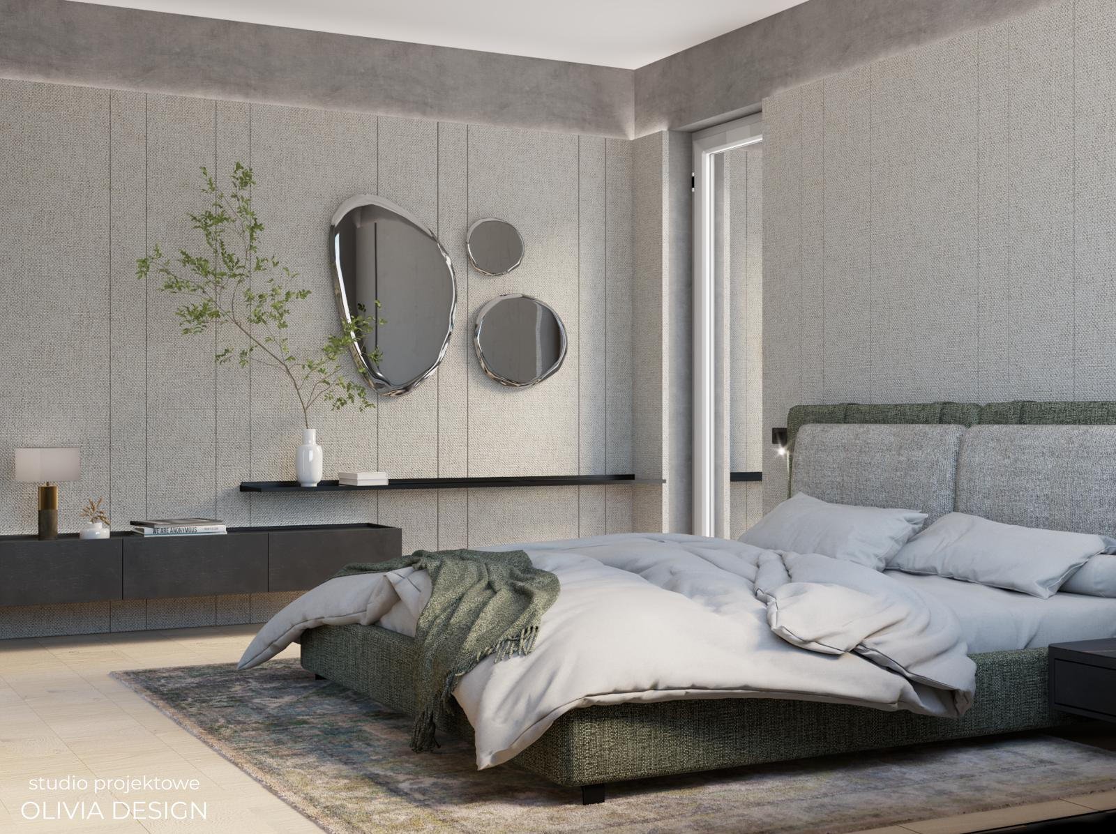 Nowoczesna sypialnia w stonowanej kolorystyce z łóżkiem z zieloną ramą, szarą pościelą i narzutą, asymetrycznymi lustrami na ścianie oraz minimalistyczną komodą z dekoracjami.