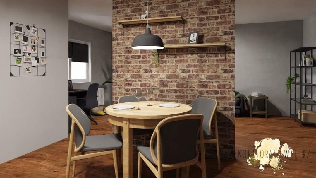 Wizualizacja jadalni z okrągłym stołem, krzesłami w szarym obiciu i ceglaną ścianą z półkami, oświetlona wiszącą lampą.