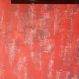 Czerwona ściana z widocznymi pociągnięciami pędzla i szarymi smugami, pionowe pęknięcie na lewej krawędzi ściany, fragment ramy obrazu u góry.