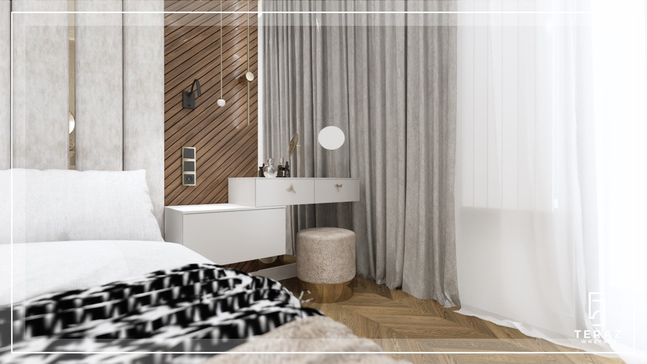 Nowoczesna sypialnia z drewnianą ścianą, toaletką z okrągłym lustrem i puszystym taboretem, oraz łóżkiem z wzorzystą narzutą.