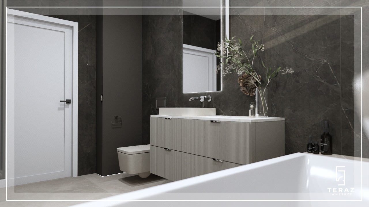 Nowoczesna łazienka w odcieniach szarości z marmurowymi płytkami, umywalką nablatową na szafce z ryflowanymi frontami, wiszącą toaletą i minimalistycznym oświetleniem lustra.