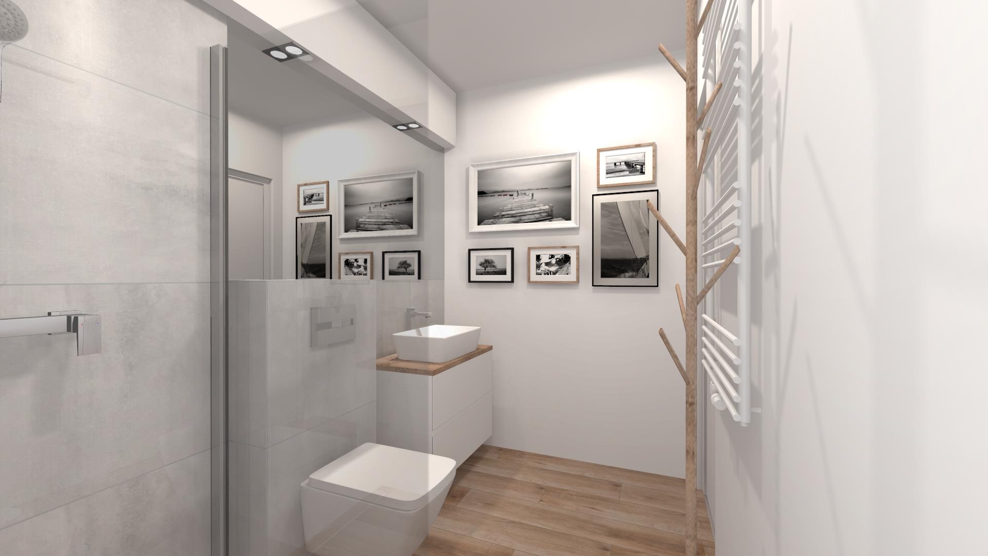 Wizualizacja minimalistycznej łazienki z drewnianą podłogą, białymi ścianami i galerią czarno-białych zdjęć nad umywalką; grzejnik drabinkowy z elementami drewnianymi po prawej stronie.
