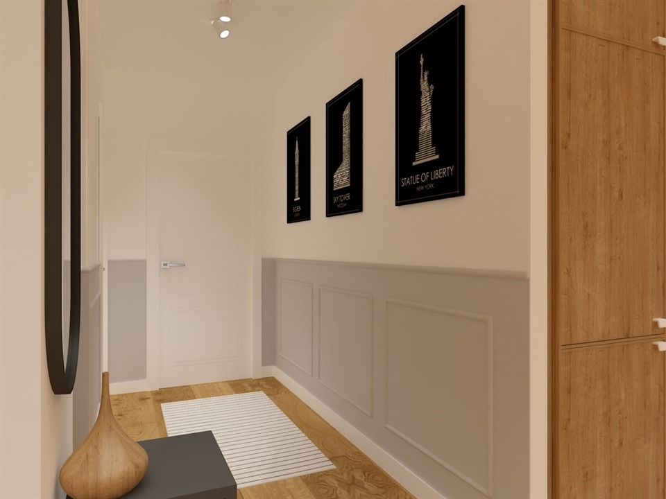 Korytarz w stylu klasycznym z drewnianą podłogą, dywanem w paski, panelami ściennymi i czarnymi obrazami przedstawiającymi Statuę Wolności i Sky Tower.