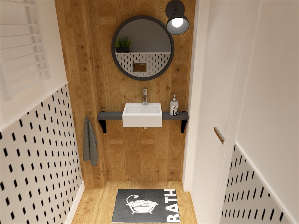 Wizualizacja małej łazienki z drewnianymi panelami, okrągłym lustrem z oświetleniem punktowym, białą umywalką nablatową na szarej półce, dywanikiem z motywem wanny i grzejnikiem drabinkowym.