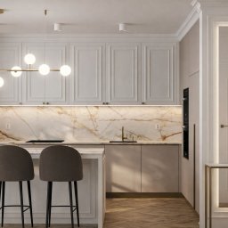 MP ARCHITEKTURA WNĘTRZ PAULINA TRACZ - Elegancka kuchnia w odcieniach beżu i bieli z marmurowym backsplash'em, oświetlona nowoczesną lampą wiszącą i trzema hokerami przy wyspie.