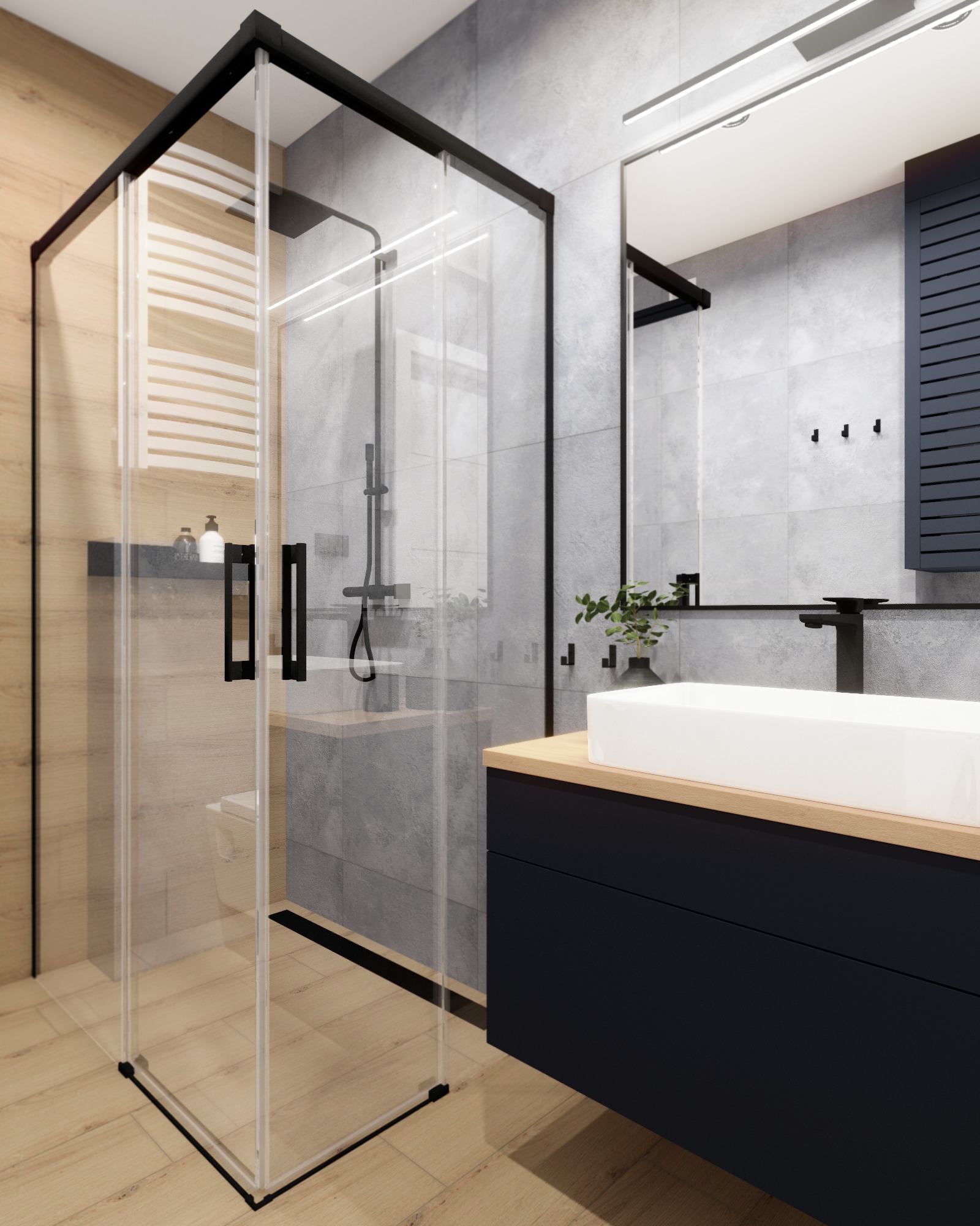 Nowoczesna łazienka z kabiną prysznicową typu walk-in z czarnymi profilami, umywalką nablatową na szafce w kolorze granatowym i szarą okładziną ścienną.