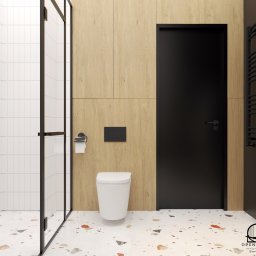 Projekt łazienki z podłogą "lastryko" i czarnymi drzwiami. Zabudowa stolarska w kolorze jasnego drewna.