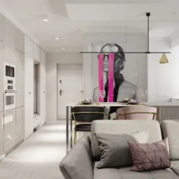 Jasne, nowoczesne wnętrze mieszkania: szara sofa z poduszkami, stół z krzesłami, zabudowa kuchenna z piekarnikiem i mikrofalówką, grafika na ścianie z motywem kobiety.