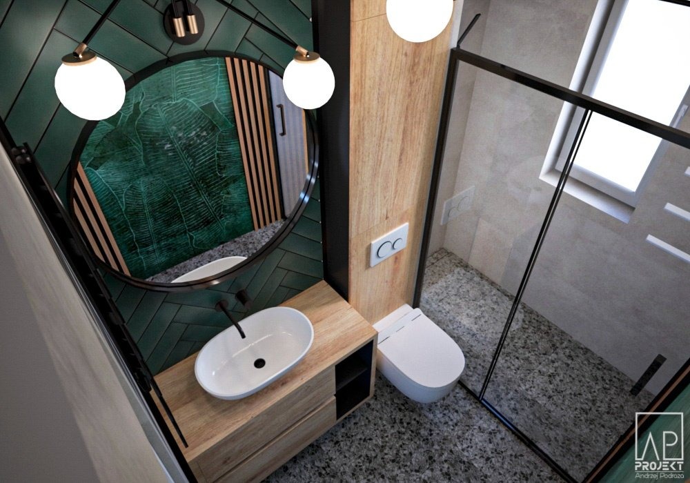 Nowoczesna łazienka z umywalką nablatową, toaletą myjącą i kabiną prysznicową ze szklaną ścianką, wykończona zielonymi płytkami w jodełkę i drewnianymi akcentami.