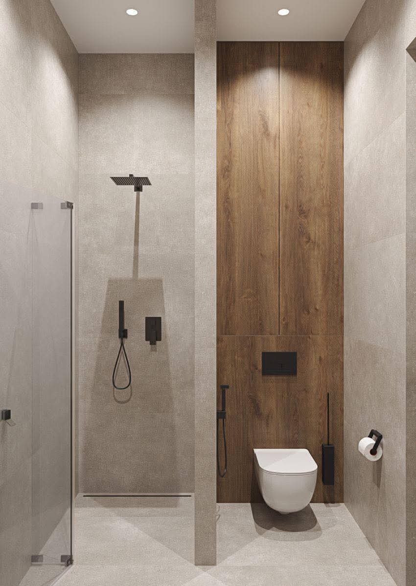 Nowoczesna łazienka z kabiną prysznicową typu walk-in, drewnianą zabudową i podtynkową toaletą. Minimalistyczny design, szara kolorystyka, oświetlenie punktowe.