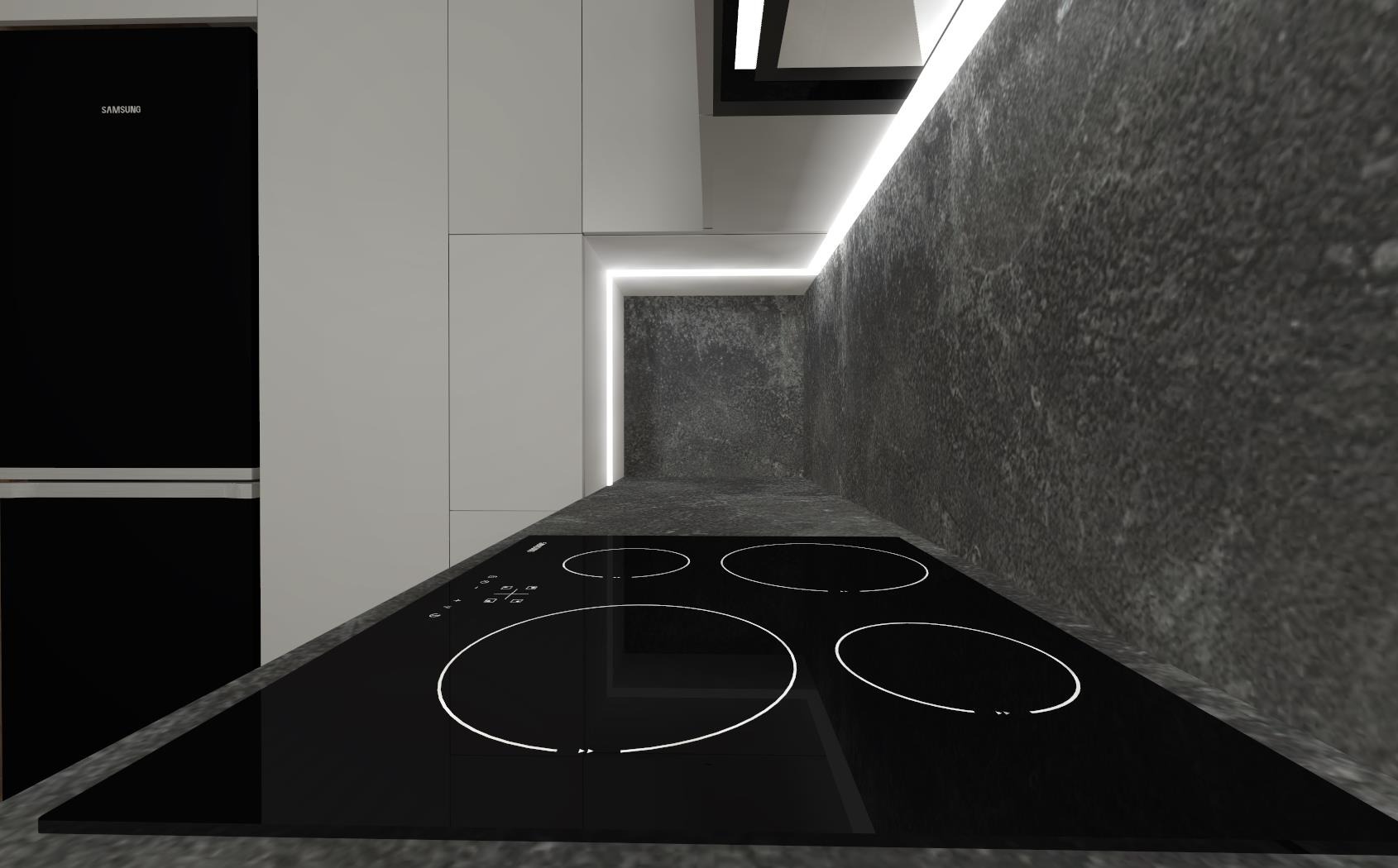 Czarna płyta indukcyjna z czterema polami grzewczymi na blacie kuchennym z szarego kamienia, w tle białe szafki i czarna lodówka Samsung.