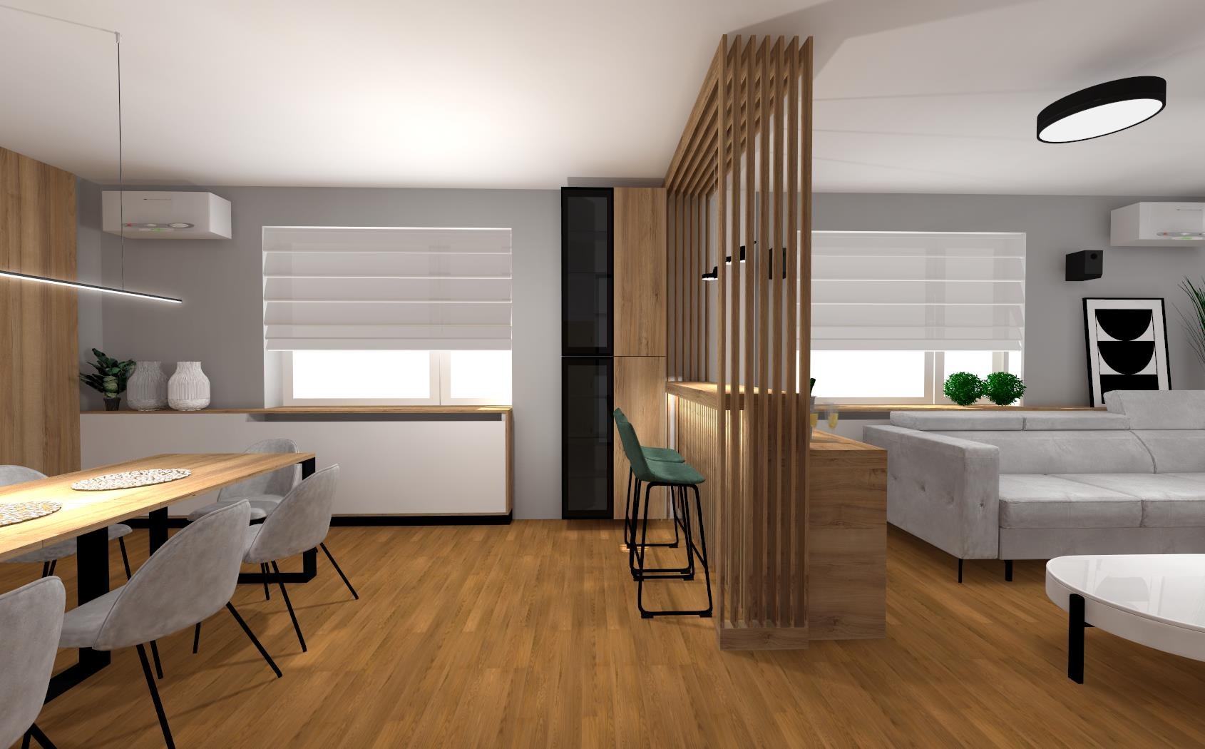 Wnętrze mieszkania z drewnianą zabudową kuchenną, stołem jadalnym z szarymi krzesłami, szarą sofą i drewnianą ścianką działową z pionowych listew.