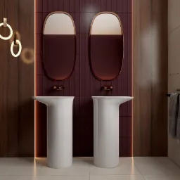 Nowoczesna łazienka z dwoma białymi umywalkami kolumnowymi, owalnymi lustrami w miedzianych ramach na tle bordowych płytek ułożonych pionowo, oraz wiszącymi lampami w kształcie pierścieni