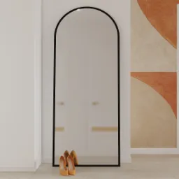 Minimalistyczny przedpokój z dużym, czarnym lustrem łukowym, beżowymi szafami z podłużnymi uchwytami i abstrakcyjną tapetą w odcieniach beżu i pomarańczy, uzupełniony parą żółtych szpilek.