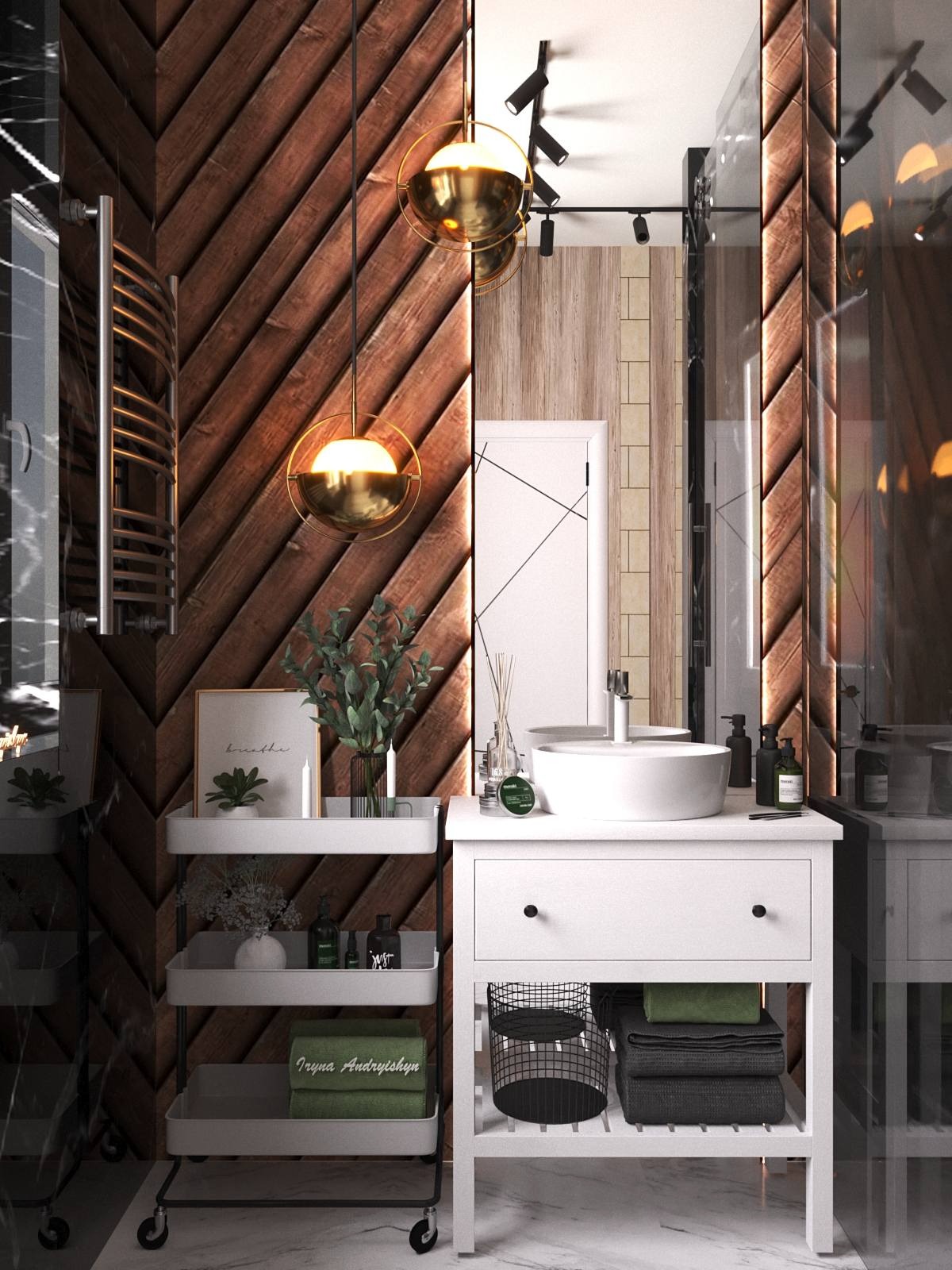 Nowoczesna łazienka z drewnianą ścianą w jodełkę, okrągłą białą umywalką nablatową i złotymi lampami wiszącymi, uzupełniona wózeczkiem z akcesoriami i ręcznikami.