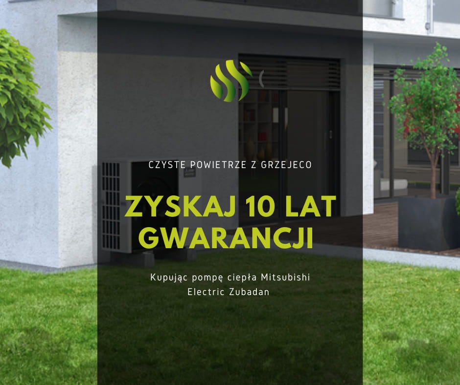 Zewnętrzna jednostka pompy ciepła Mitsubishi Electric Zubadan na trawniku przed nowoczesnym budynkiem, z informacją o 10-letniej gwarancji i logo firmy.