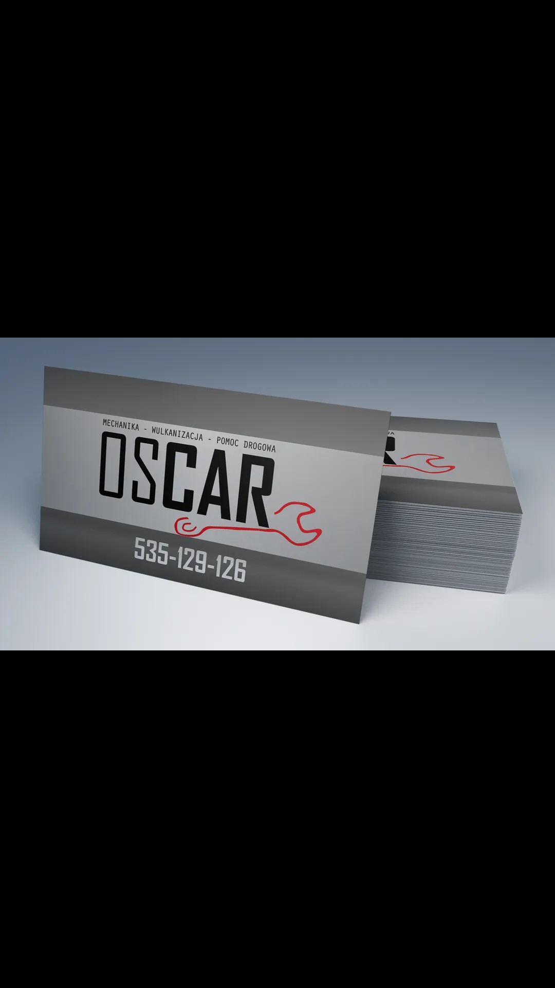 Wizytówki firmy Oscar oferującej mechanikę, wulkanizację i pomoc drogową, z numerem telefonu 535-129-126 oraz logo w postaci klucza francuskiego.