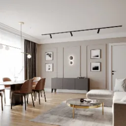 Salon w neutralnych barwach z drewnianą podłogą, szarym dywanem, beżową sofą i stołem jadalnym z krzesłami z brązowej skóry ekologicznej. Na ścianie czarne obrazy w białych ramkach i szafka RTV...
