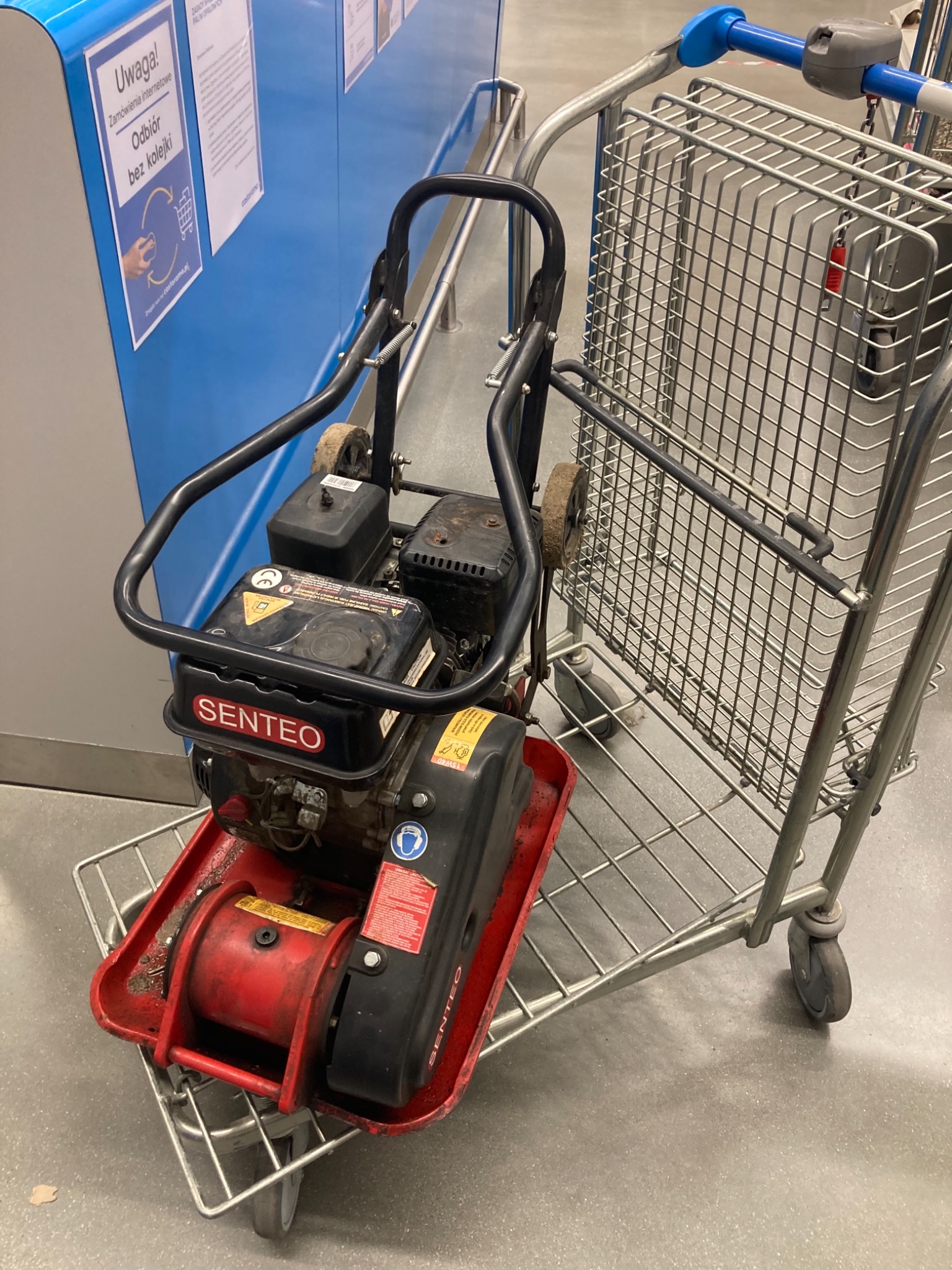 Zagęszczarka gruntu marki Senteo na wózku sklepowym, widoczna w markecie budowlanym