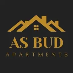 Złote logo firmy budowlanej AS BUD APARTMENTS na ciemnoszarym tle, przedstawiające stylizowany zarys domu z trzema spadzistymi dachami i oknem na środku.