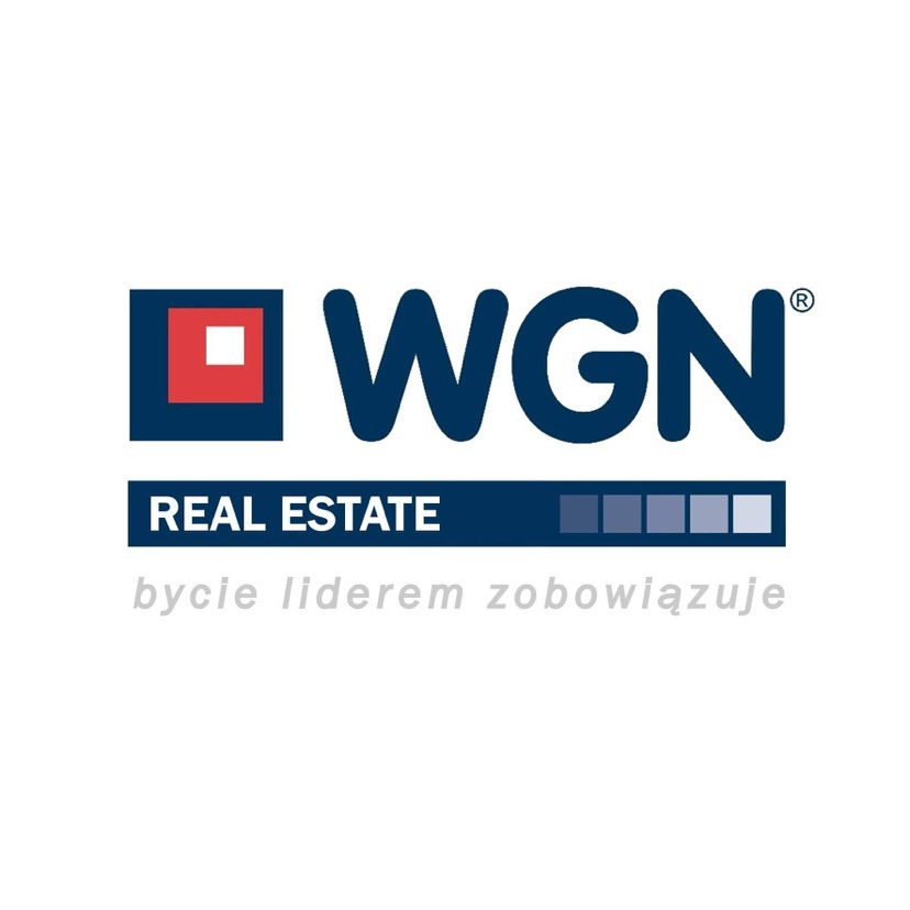 Logo firmy WGN Real Estate z hasłem 'bycie liderem zobowiązuje' i elementami graficznymi w kolorach czerwonym i granatowym.