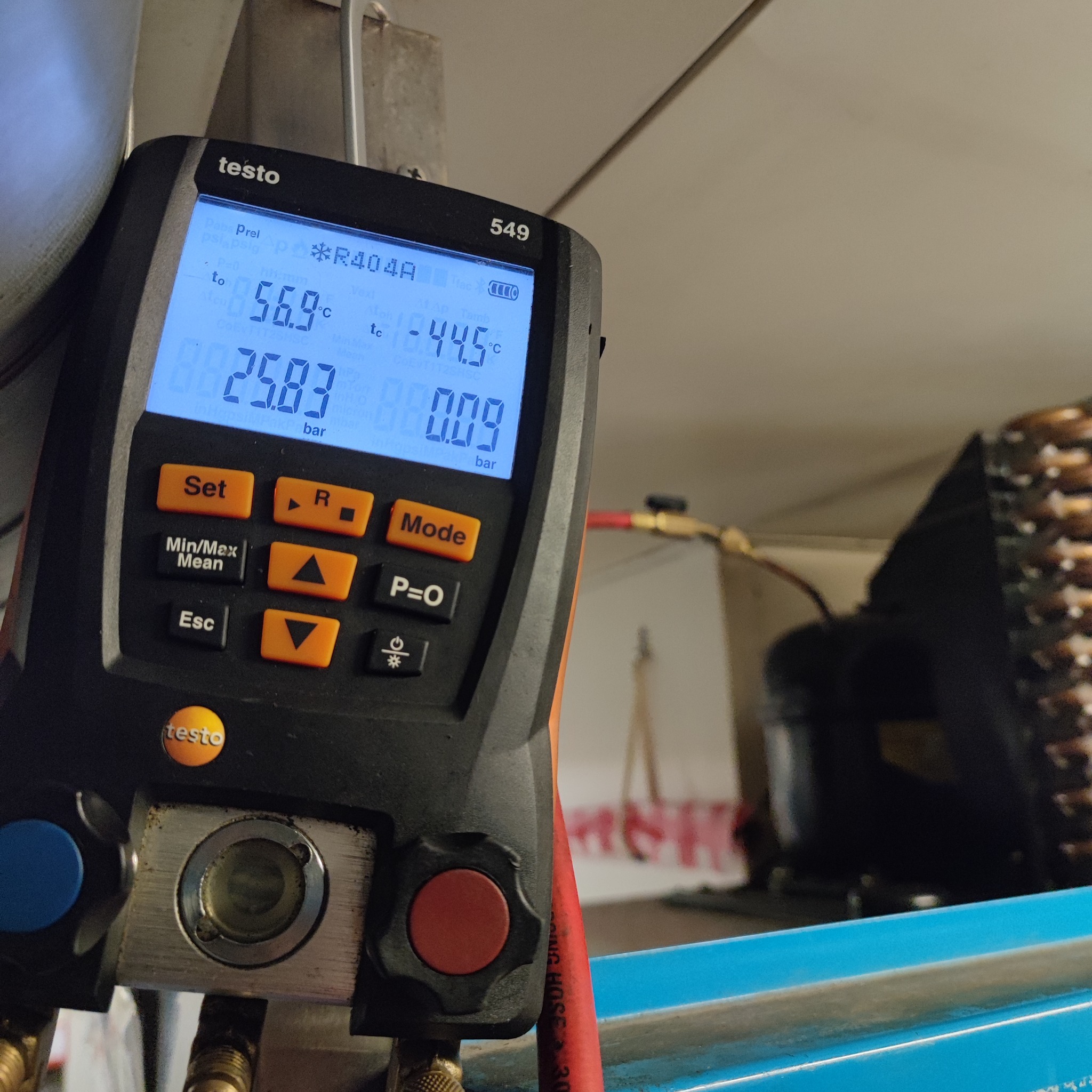 Miernik cyfrowy Testo 549 podłączony do instalacji chłodniczej, wyświetlający wartości ciśnienia i temperatury czynnika R404A podczas diagnostyki.