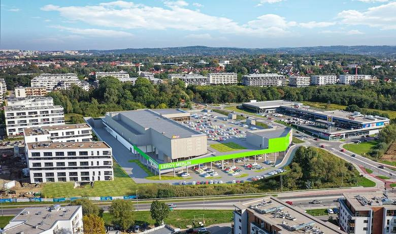 Wizualizacja z lotu ptaka budynku handlowego Leroy Merlin z parkingiem, otoczonego zabudową miejską i zielenią.