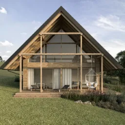 Wizualizacja nowoczesnego domu w stylu stodoły z drewnianą konstrukcją, dużymi przeszkleniami i tarasem z leżakami oraz wiszącym fotelem, otoczonego zielonym trawnikiem i wzgórzami.