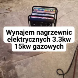 Przenośny agregat grzewczy Mal-Tap na posadzce w trakcie pracy, widoczny kabel zasilający i fragment grzejnika ściennego.