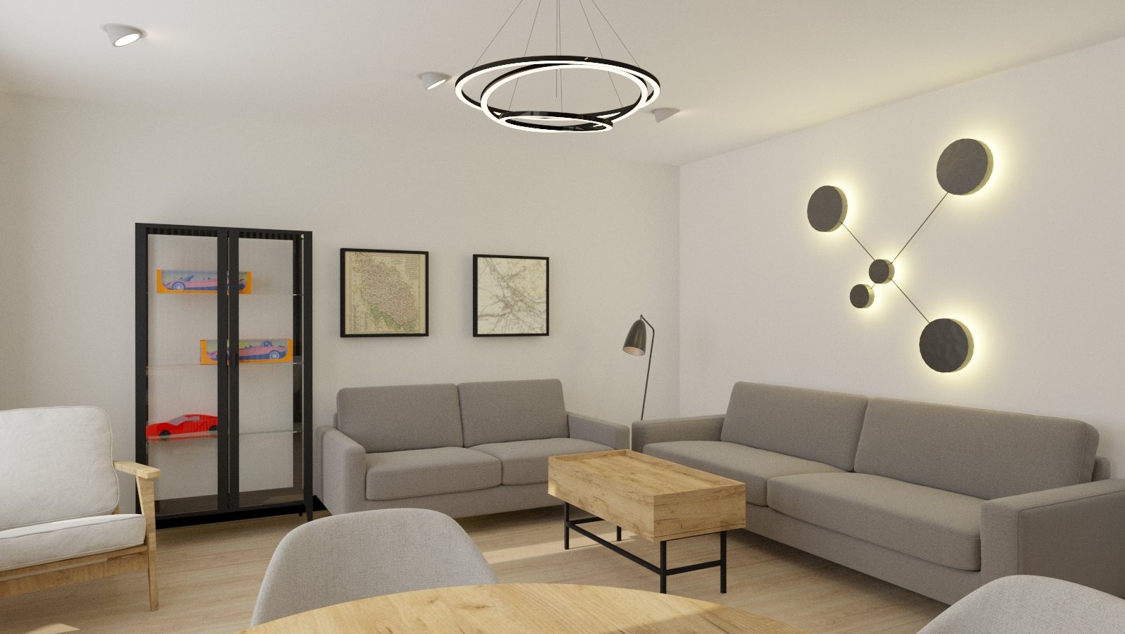 Salon w neutralnych barwach z szarymi sofami, drewnianym stolikiem kawowym i okrągłą lampą wiszącą, uzupełniony o czarną witrynę z kolekcją modeli samochodów.