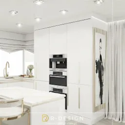 Minimalistyczna, biała kuchnia z wyspą z blatem imitującym marmur, zabudową na całej ścianie z wbudowanym ekspresem do kawy i piekarnikiem, oraz obrazem w stonowanych barwach.