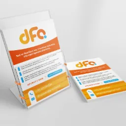 Dwa przezroczyste stojaki na ulotki prezentujące pomarańczowo-błękitne projekty z logo 'dfa', hasłem i danymi kontaktowymi na białym tle.