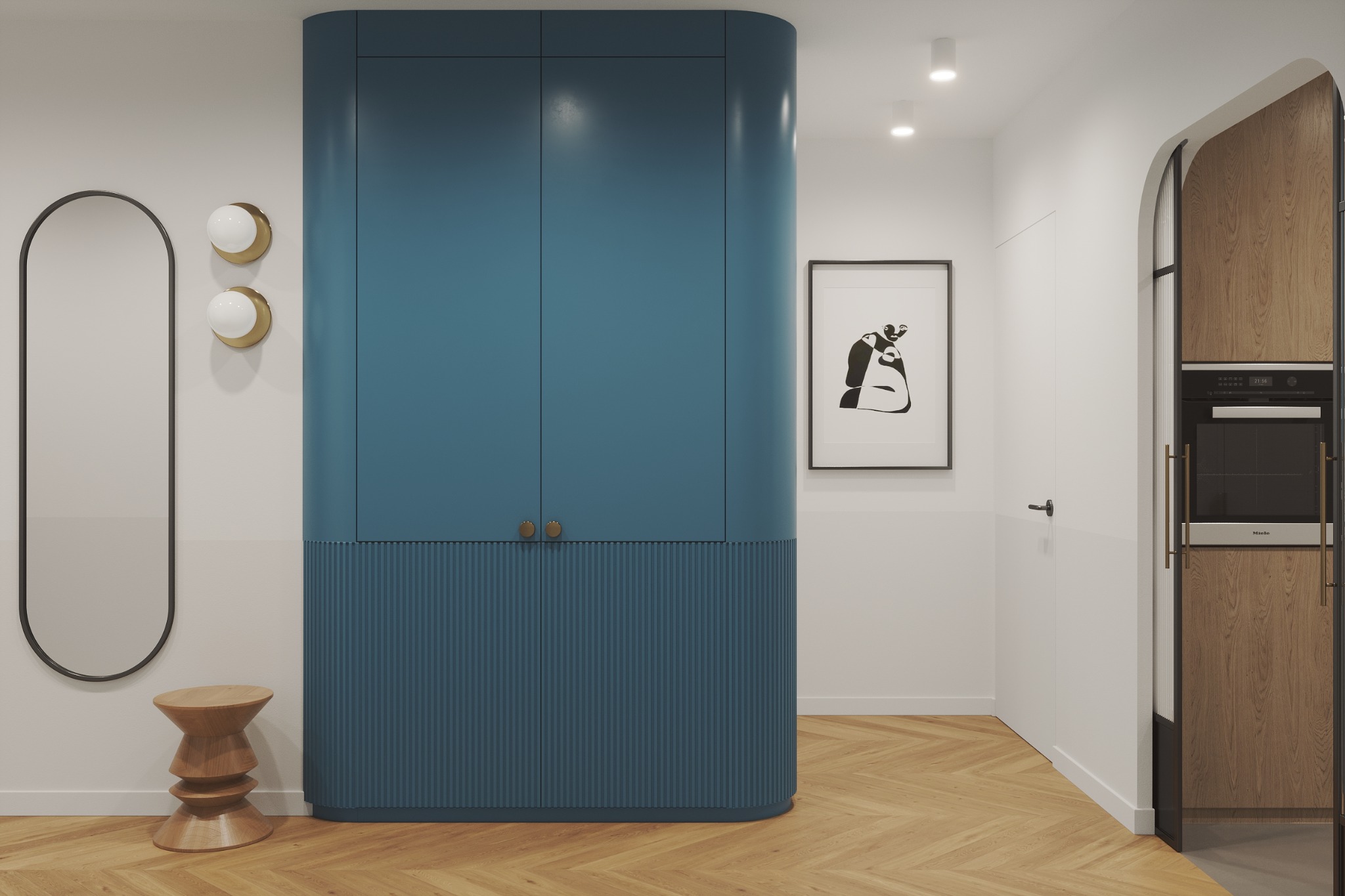 Nowoczesne wnętrze przedpokoju z zabudową w kolorze petrol, drewnianym parkietem w jodełkę, owalnym lustrem i designerskim stołkiem.